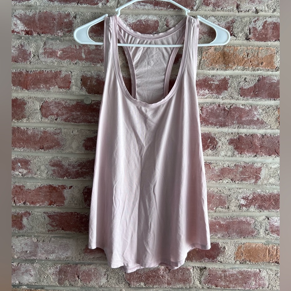 Lululemon baby pink racer back top. Size 8. Small stains pictured.